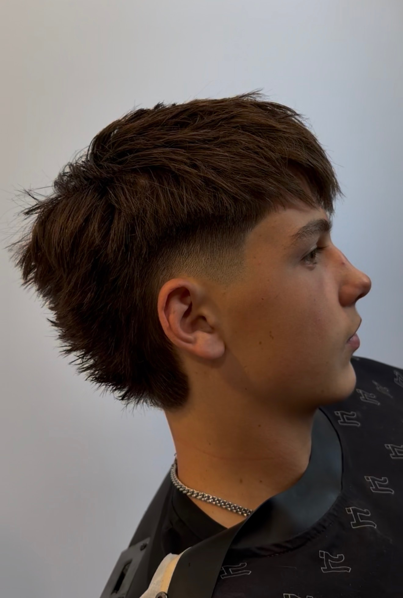 Textured taper haircut with low fade, back view, cut by Acero by Omar in South Jordan, UT